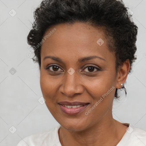 Joyful black young-adult female with short  brown hair and brown eyes