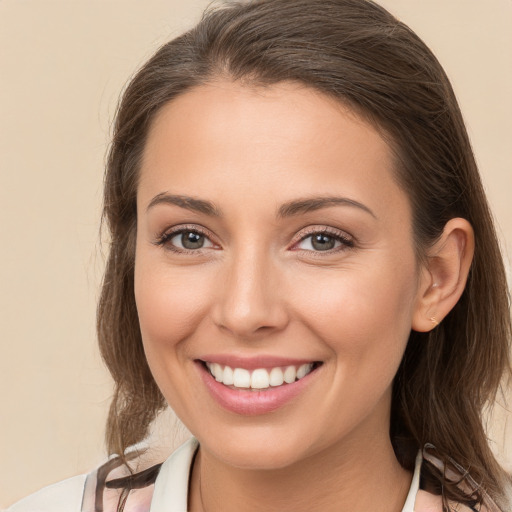 Joyful white young-adult female with long  brown hair and brown eyes