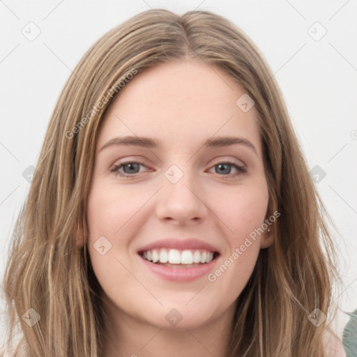 Joyful white young-adult female with long  brown hair and green eyes