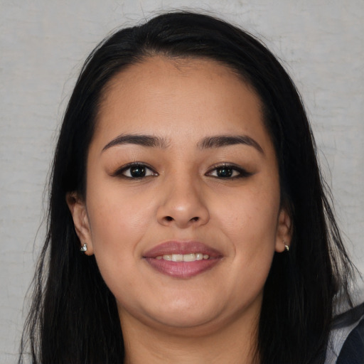 Joyful asian young-adult female with long  brown hair and brown eyes