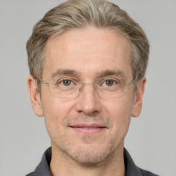 Joyful white middle-aged male with short  brown hair and grey eyes