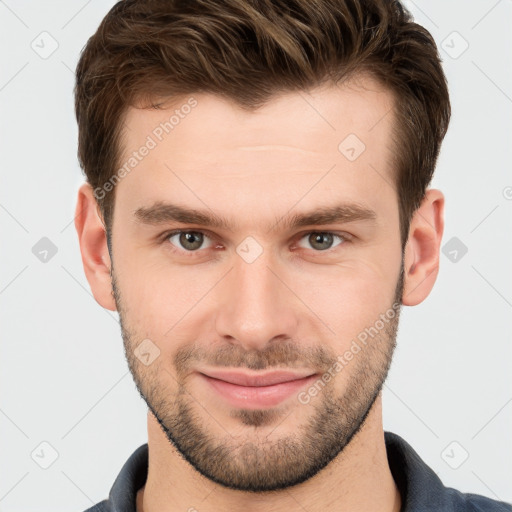 Joyful white young-adult male with short  brown hair and grey eyes