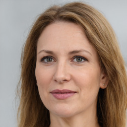 Joyful white adult female with long  brown hair and brown eyes