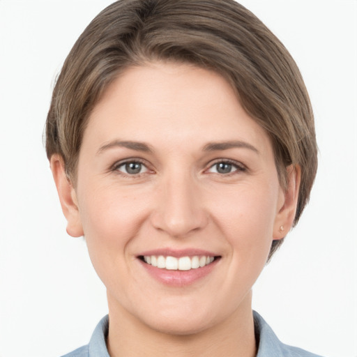 Joyful white young-adult female with short  brown hair and grey eyes