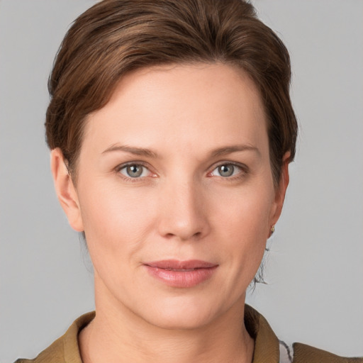 Joyful white young-adult female with short  brown hair and grey eyes