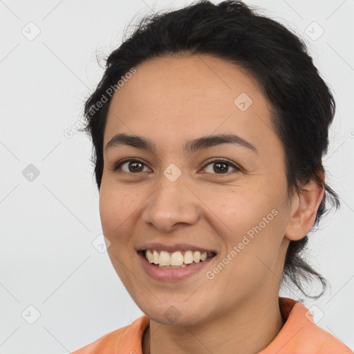 Joyful latino young-adult female with short  brown hair and brown eyes