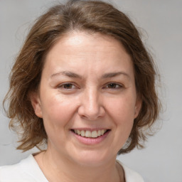 Joyful white adult female with medium  brown hair and brown eyes