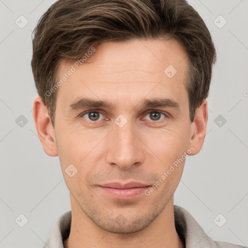 Joyful white young-adult male with short  brown hair and grey eyes