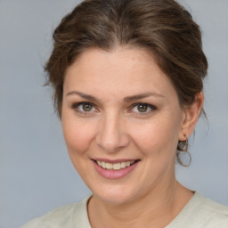 Joyful white adult female with medium  brown hair and brown eyes