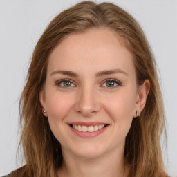 Joyful white young-adult female with long  brown hair and green eyes