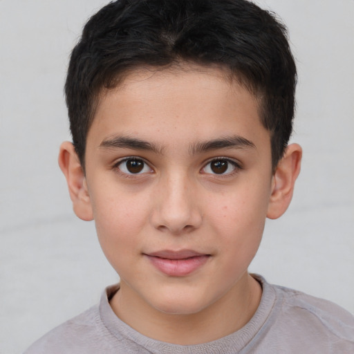 Joyful white child male with short  brown hair and brown eyes