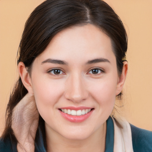 Joyful white young-adult female with long  brown hair and brown eyes