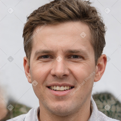 Joyful white adult male with short  brown hair and grey eyes