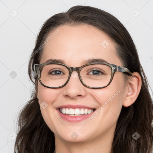 Joyful white young-adult female with long  brown hair and blue eyes