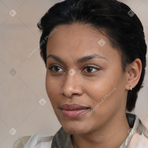 Joyful black young-adult female with short  black hair and brown eyes