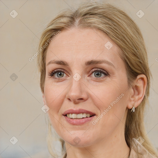 Joyful white adult female with medium  brown hair and blue eyes