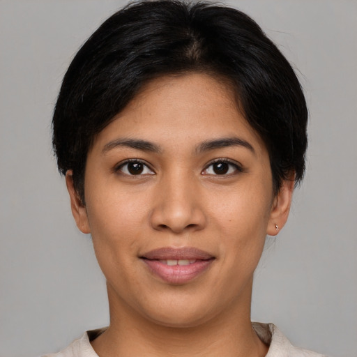 Joyful latino young-adult female with short  brown hair and brown eyes