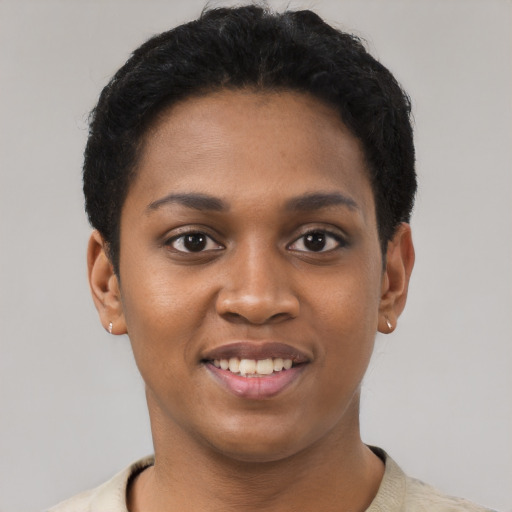 Joyful black young-adult female with short  black hair and brown eyes