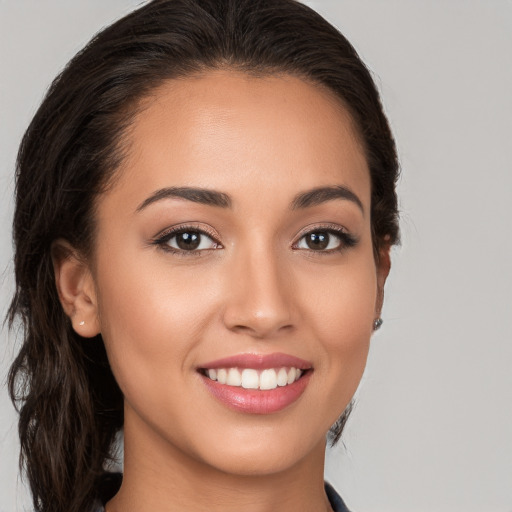 Joyful white young-adult female with long  brown hair and brown eyes