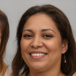 Joyful white adult female with long  brown hair and brown eyes