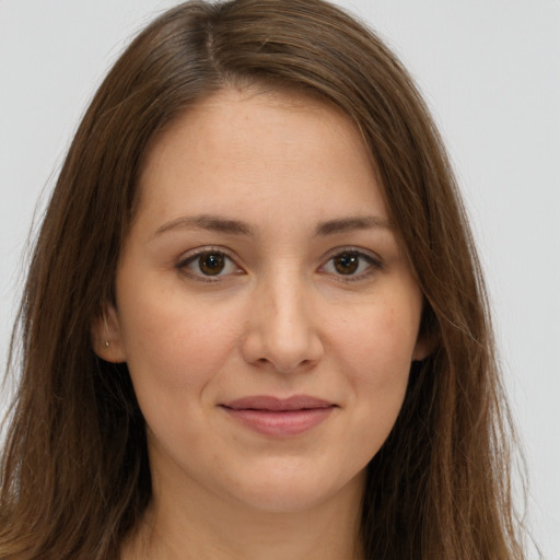 Joyful white young-adult female with long  brown hair and brown eyes