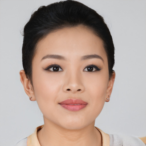 Joyful asian young-adult female with short  black hair and brown eyes