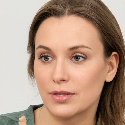 Joyful white young-adult female with long  brown hair and blue eyes