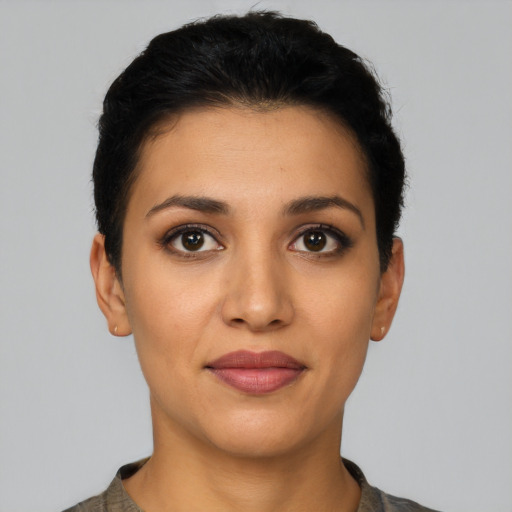 Joyful latino young-adult female with short  black hair and brown eyes