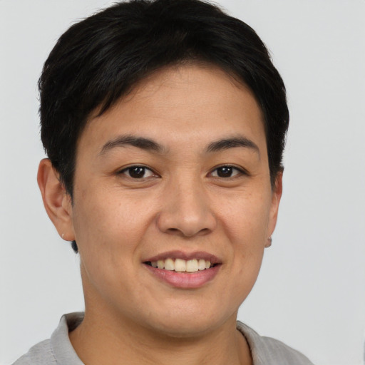 Joyful asian young-adult female with short  brown hair and brown eyes