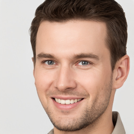 Joyful white young-adult male with short  brown hair and brown eyes