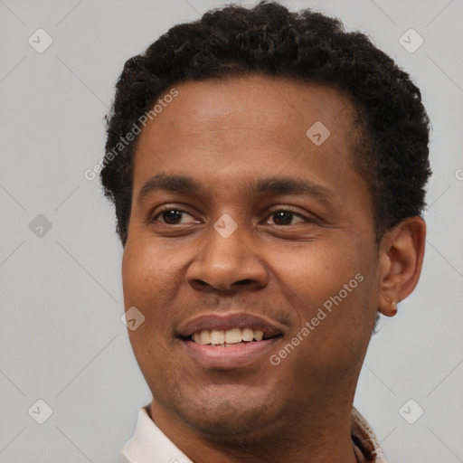 Joyful latino young-adult male with short  brown hair and brown eyes