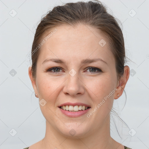 Joyful white young-adult female with medium  brown hair and grey eyes