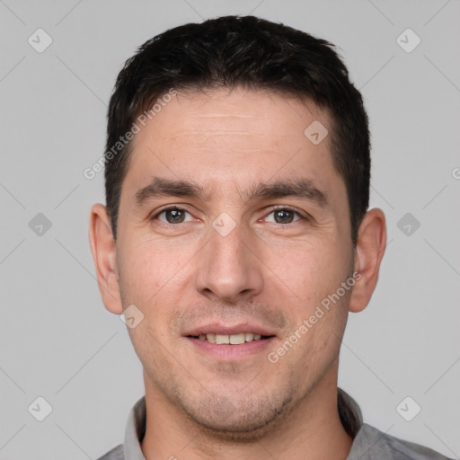 Joyful white young-adult male with short  brown hair and brown eyes