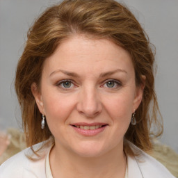 Joyful white young-adult female with medium  brown hair and blue eyes