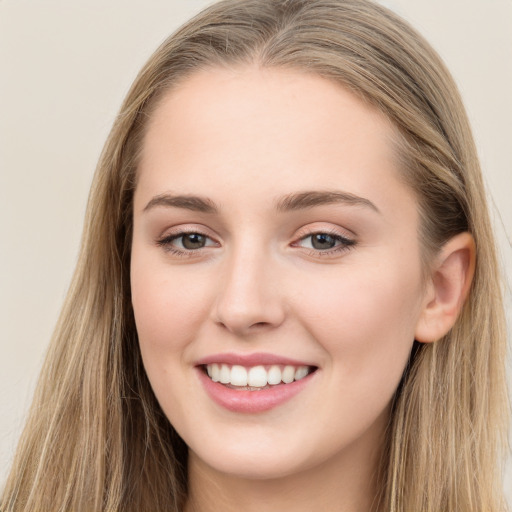 Joyful white young-adult female with long  brown hair and grey eyes