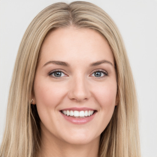 Joyful white young-adult female with long  brown hair and blue eyes