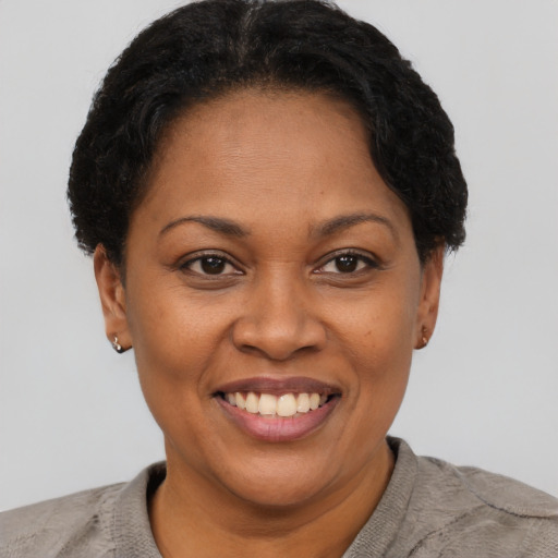 Joyful latino adult female with short  brown hair and brown eyes