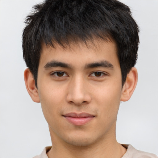 Joyful asian young-adult male with short  brown hair and brown eyes