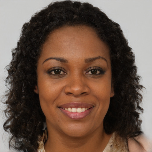 Joyful black young-adult female with medium  brown hair and brown eyes