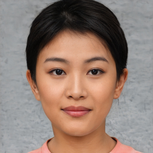 Joyful asian young-adult female with short  brown hair and brown eyes