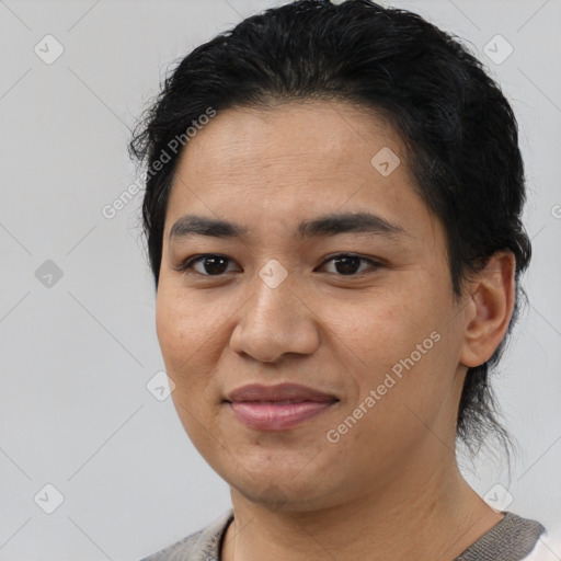 Joyful latino young-adult female with short  black hair and brown eyes