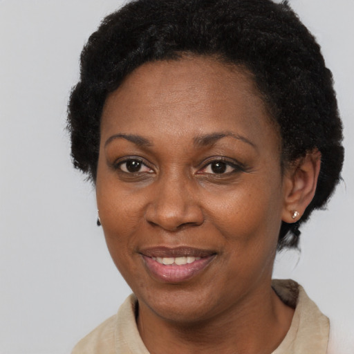 Joyful black adult female with short  black hair and brown eyes