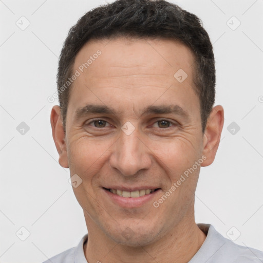 Joyful white adult male with short  brown hair and brown eyes