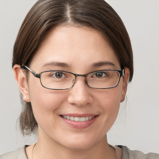 Joyful white young-adult female with short  brown hair and grey eyes