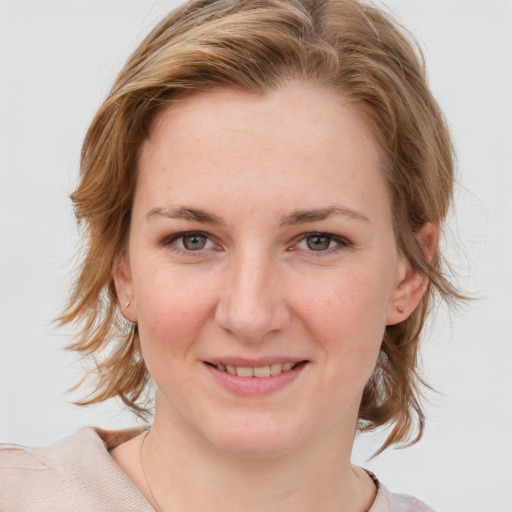 Joyful white young-adult female with medium  brown hair and blue eyes