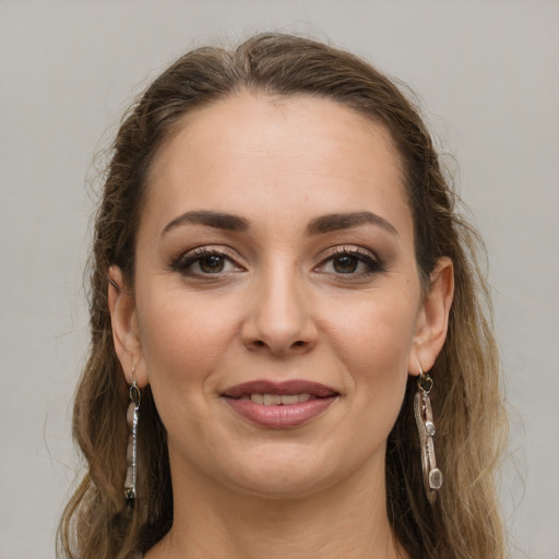 Joyful white young-adult female with long  brown hair and grey eyes