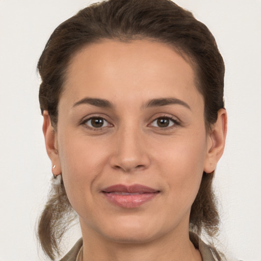 Joyful white young-adult female with medium  brown hair and brown eyes