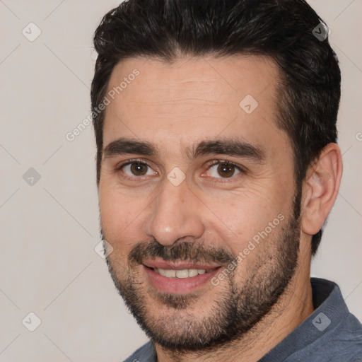 Joyful white young-adult male with short  black hair and brown eyes