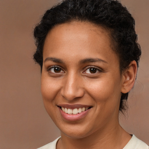 Joyful latino young-adult female with short  brown hair and brown eyes