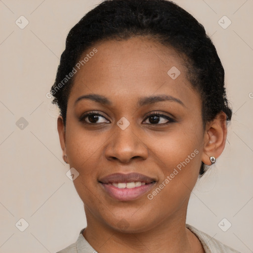 Joyful black young-adult female with short  brown hair and brown eyes